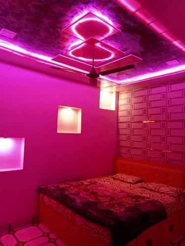een slaapkamer met paarse verlichting aan het plafond bij Shi Ram lala Palace in Ayodhya