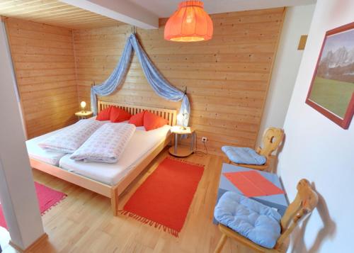 a bedroom with a bed with a canopy at Apartmentpension Hillebrand in Kitzbühel