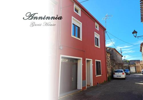 a red building on the side of a street at Anninnìa Guest House B&B - GhiIarza in Ghilarza