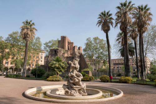 a fountain in front of a building with palm trees at STELLA GUEST HOUSE O AFFITTACAMERE in Rome