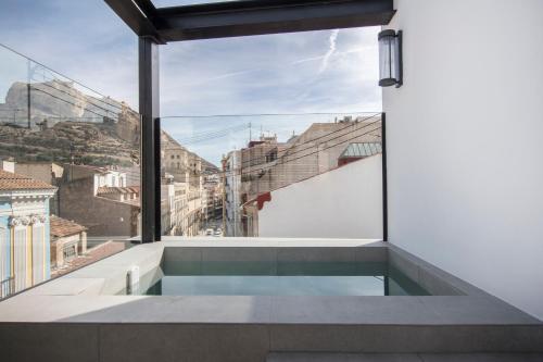 a view from the balcony of a house with a swimming pool at RS Boutique Apartments in Alicante