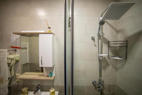a bathroom with a shower with a glass door at Belona Hotel in Kutaisi