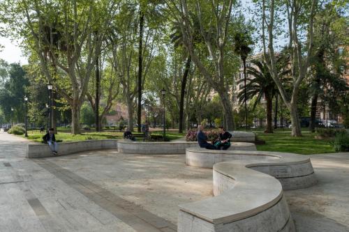 people sitting on benches in a park with trees at STELLA GUEST HOUSE O AFFITTACAMERE in Rome