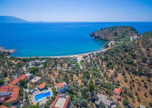 an aerial view of a beach and the ocean at Limnionas Bay Village Hotel in Marathokampos