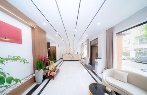 a hallway with a living room with a couch at Lam Anh Hotel 6 Ngoại Giao Đoàn BT4-10 in Hanoi