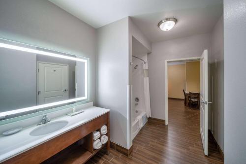 a bathroom with a sink and a large mirror at La Quinta by Wyndham Houston NW Beltway8/WestRD in Houston