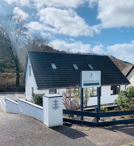 a white house with a sign in front of it at Inverasdale in Oban