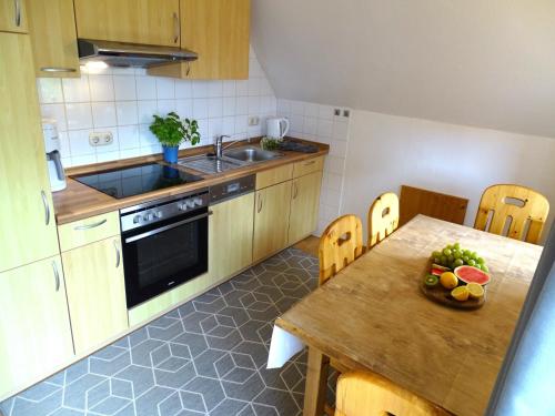 a kitchen with a table and a sink and a counter top at Seestern in Grömitz