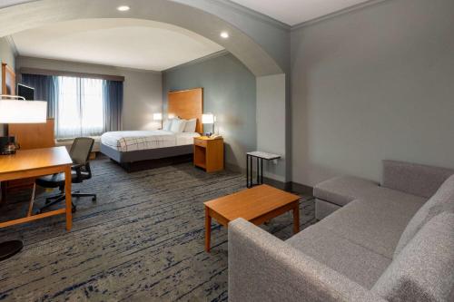 a hotel room with a bed and a desk at La Quinta by Wyndham Bridgeport in Bridgeport