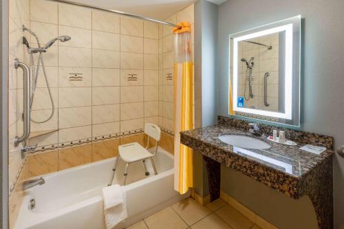 a bathroom with a sink and a tub and a shower at La Quinta by Wyndham Bridgeport in Bridgeport