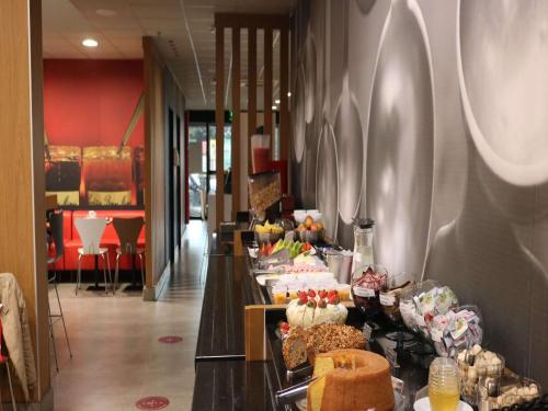 a buffet line with cakes and other desserts on display at ibis Catalao in Catalão