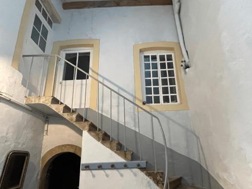 a staircase leading up to a building with a window at Gîte Le Thabor in Cluny
