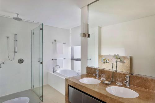 a bathroom with two sinks and a shower at Conrad Abu Dhabi Etihad Towers in Abu Dhabi