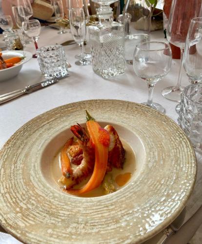 a plate with some food on a table at Maison Georges in Tourcoing