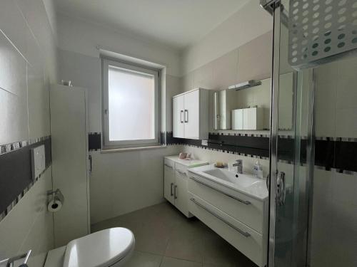 a bathroom with a sink and a shower and a toilet at Casa Rosaria in Lecce