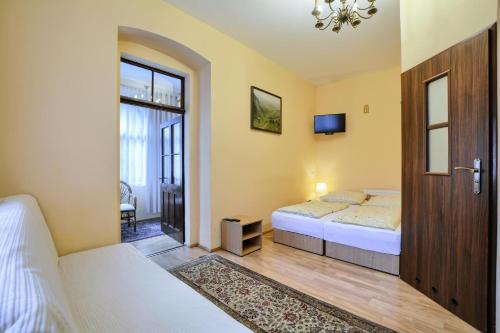 a bedroom with two beds and a sliding door at Dom Polana Karpacz in Karpacz