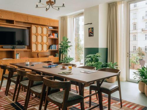a dining room with a table and chairs at The Hoxton Vienna in Vienna