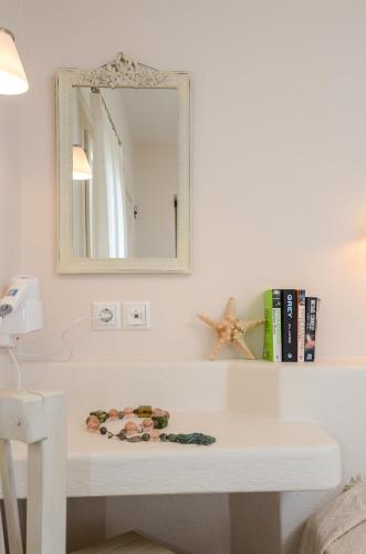 a white table in a room with a mirror at Irini Studios in Agia Anna Naxos