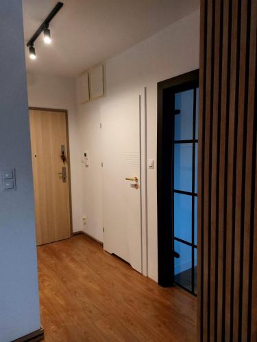 an empty room with a hallway with a door at Celine Apartments in Lębork