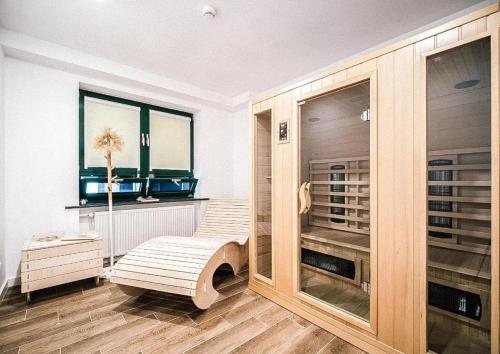 a room with a walk in closet with wooden cabinets at Apartament nad Zalewem in Serock