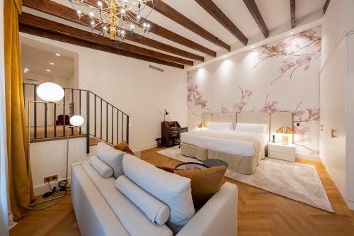 a living room with a bed and a couch at Palacio Ca Sa Galesa in Palma de Mallorca