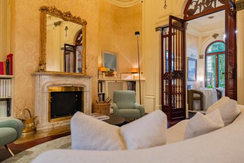 a living room with a fireplace and a mirror at Palacio Ca Sa Galesa in Palma de Mallorca