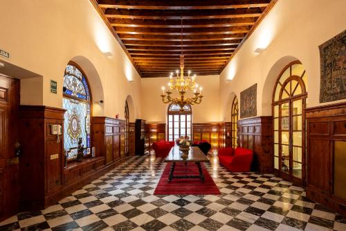 a large room with a table and a chandelier at Palacio Ca Sa Galesa in Palma de Mallorca