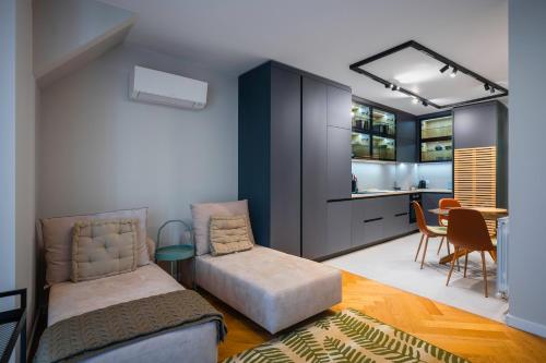 a living room with a couch and a table at Exclusive One-Bedroom Retreat in Sofia