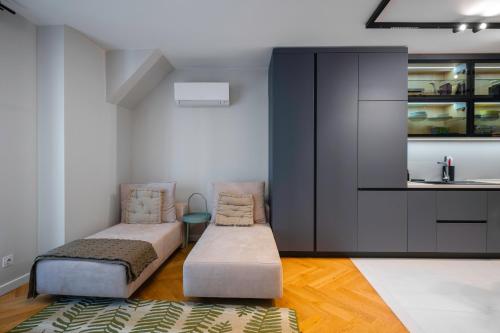 a room with a bed and a couch and a kitchen at Exclusive One-Bedroom Retreat in Sofia