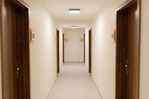 a corridor of a hallway with doors and a long hallway at Gwiazda Morza in Sianozety