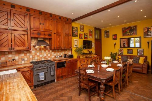 a kitchen with a wooden table and a dining room at ※ Stunning, Large Chapel, Nr Bath (EC) ※ in Box