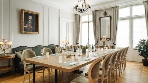 a dining room with a long table and chairs at Hôtel Lancaster Paris Champs-Elysées in Paris
