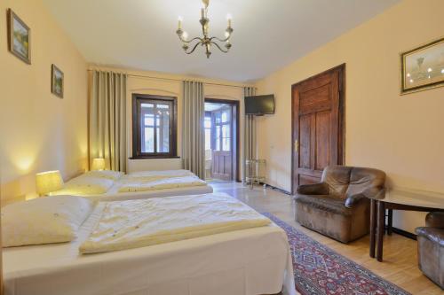1 dormitorio con 2 camas, escritorio y lámpara de araña en Dom Polana Karpacz, en Karpacz