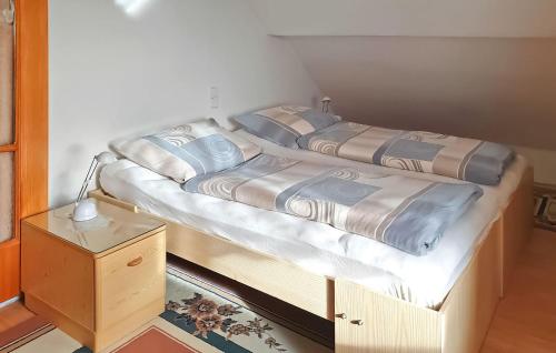 two twin beds in a room with a night stand at Nice Apartment In Breitenbrunn With Wifi in Breitenbrunn