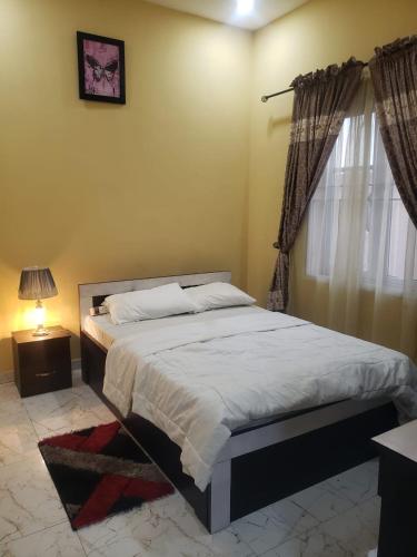 1 dormitorio con 1 cama grande y ventana en Truth Key Hotel & Suites en Lagos