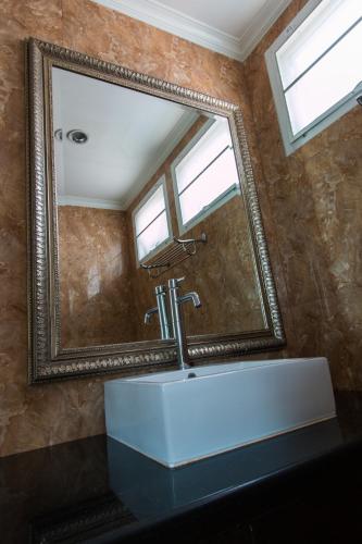 a bathroom with a large mirror and a sink at Suntosa Resort in Ko Larn