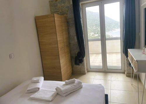 a bedroom with a bed with towels on it at Royal View in Mani in Kokkala