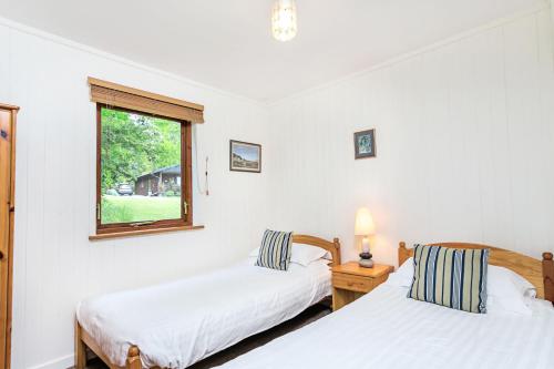 Ліжко або ліжка в номері Pine Tree Lodge