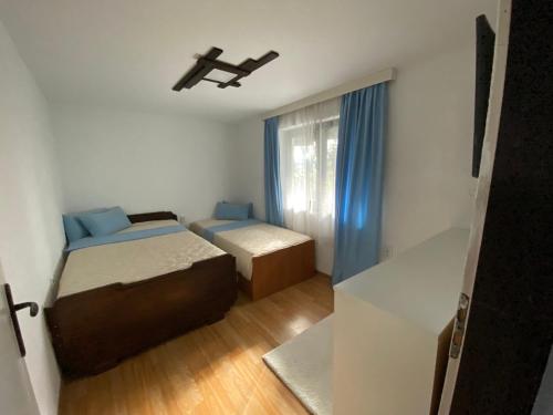 a small bedroom with two beds and a window at Къща за гости “Дългая” in Targovishte