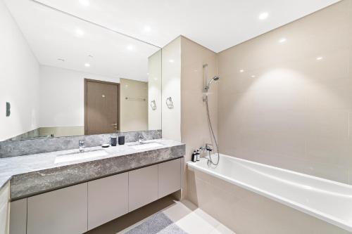 a bathroom with a tub and a sink and a shower at Luxury 2 Bedroom Apartment - Next to Dubai Opera in Dubai