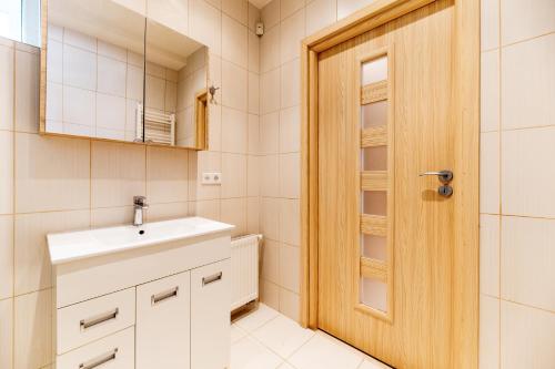 a bathroom with a sink and a mirror at Ozo park apartments in Vilnius