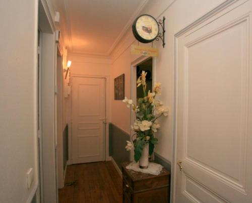 een hal met een klok en een vaas met bloemen bij Jeux olympiques Paris colocation chambre double dans F3 in Parijs