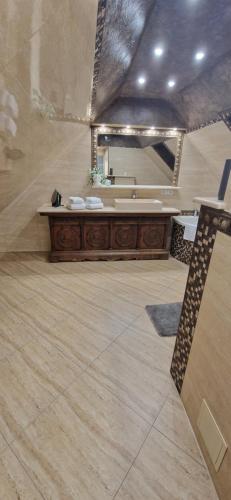 a bathroom with a sink and a large mirror at ewja 3 in Sulęcin