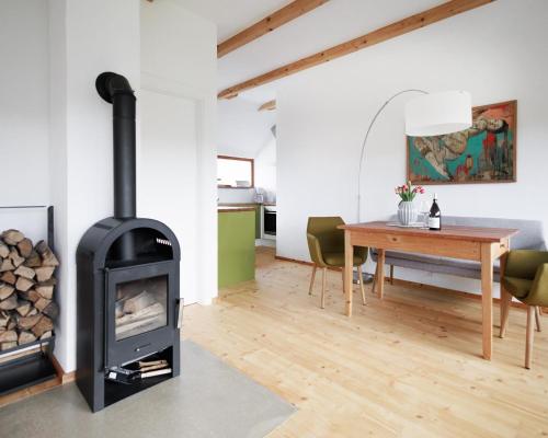 a living room with a stove and a table at Ferienwohnung OberGuess in Leutschach