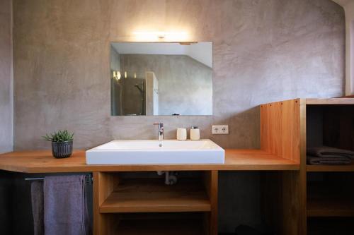 a bathroom with a white sink and a mirror at Ferienwohnung OberGuess in Leutschach