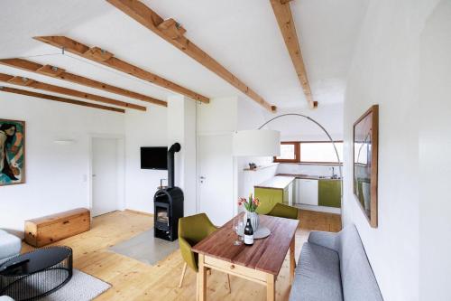 a living room with a wooden table and a couch at Ferienwohnung OberGuess in Leutschach