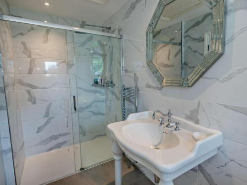 a bathroom with a sink and a shower at Riverside House in Cookham