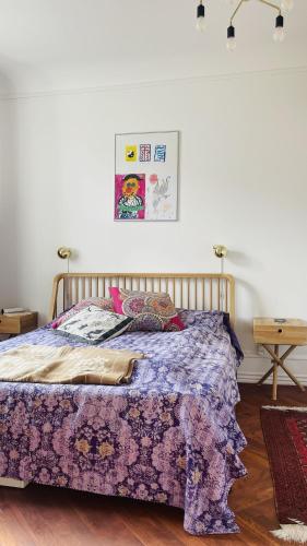 a bedroom with a bed with a purple comforter at ApartmentInCopenhagen Apartment 1604 in Copenhagen