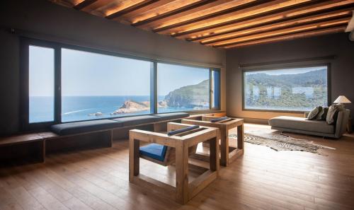 a living room with a view of the ocean at BYPILLOW Cap Sa Sal in Begur