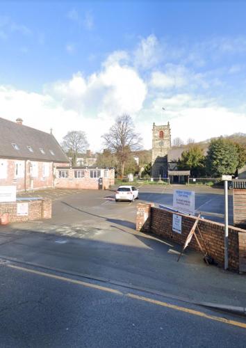 a car parked in a parking lot next to a building at Prince of wales accommodation in Llangollen